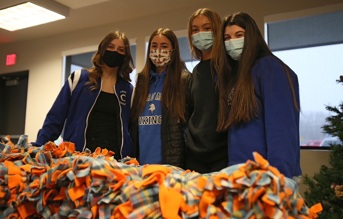 Coeur d'Alene High Junior Class reps. (from left) Rachel Gourley, Amy Corette, Myah Rietze and Ellie Morrisroe delivered 12 hand-tied blankets to North Idaho CASA on Thursday as part of a class community service project. The blankets will provide comfort and warmth for local kids going through neglect and abuse.