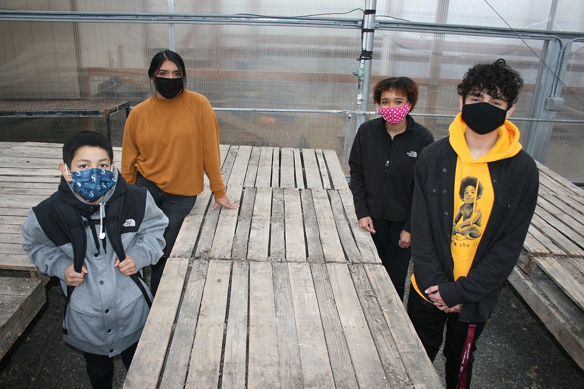 Moses Lake High School agriculture teacher Tony Kern said he could really use some new tables in the MLHS greenhouse, part of Kern's ultimate garden gift list. Ag students (from left) Luis Rodriguez, Michelle Aranda, Ashura Wren and Martin Rodriguez show off the old tables.