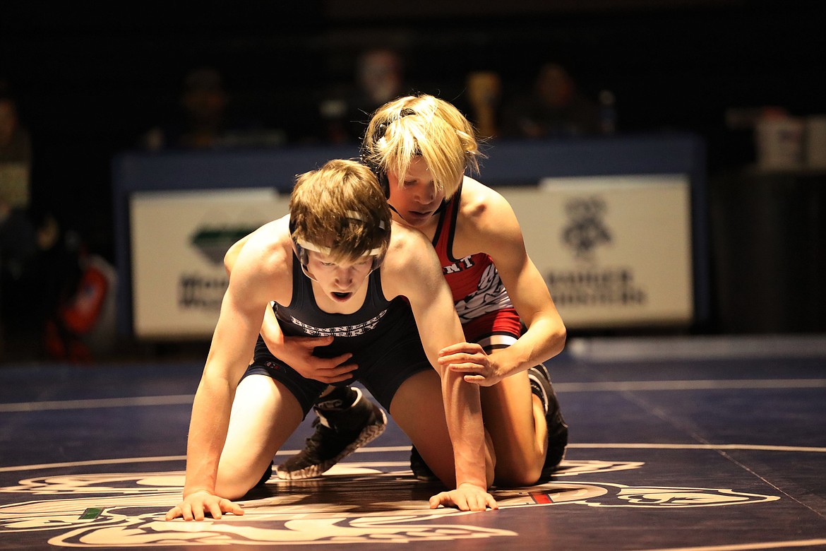 Sandpoint's Forest Ambridge (top) takes on Bonners Ferry's Michael Stindt on Thursday.