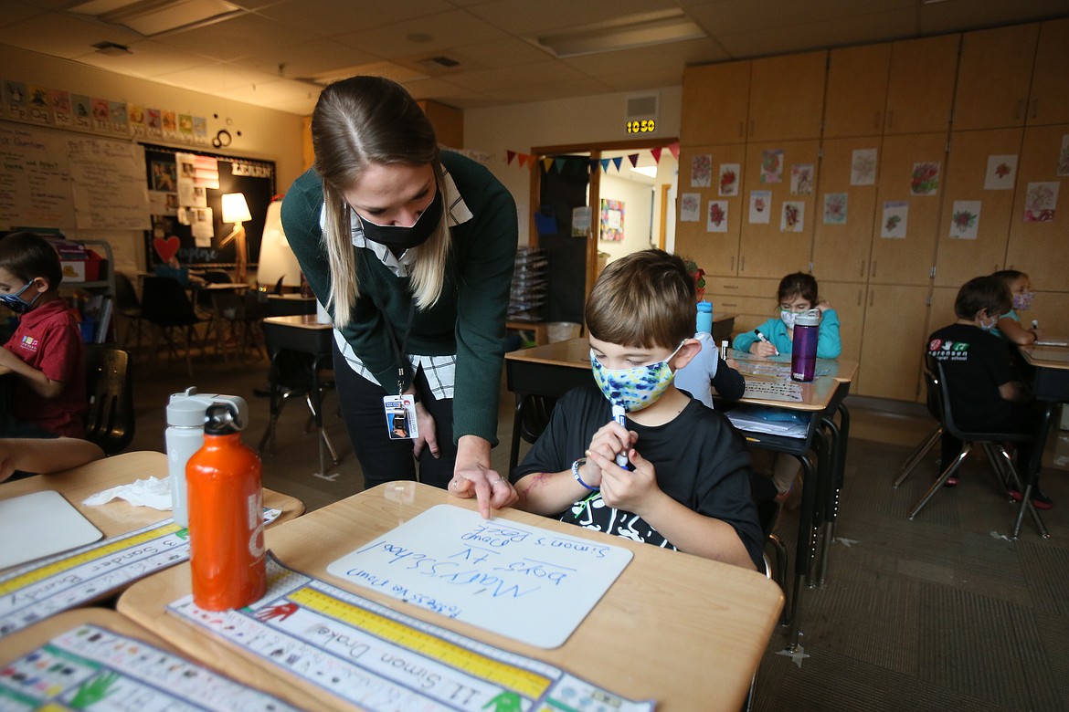 Student teacher Mary Vetsch assists second-grader Simon Drake with a writing assignment on Friday. Despite entering her teaching career amid the COVID-19 pandemic, Vetsch is encouraged, inspired and ready to take on the challenges that lie ahead.