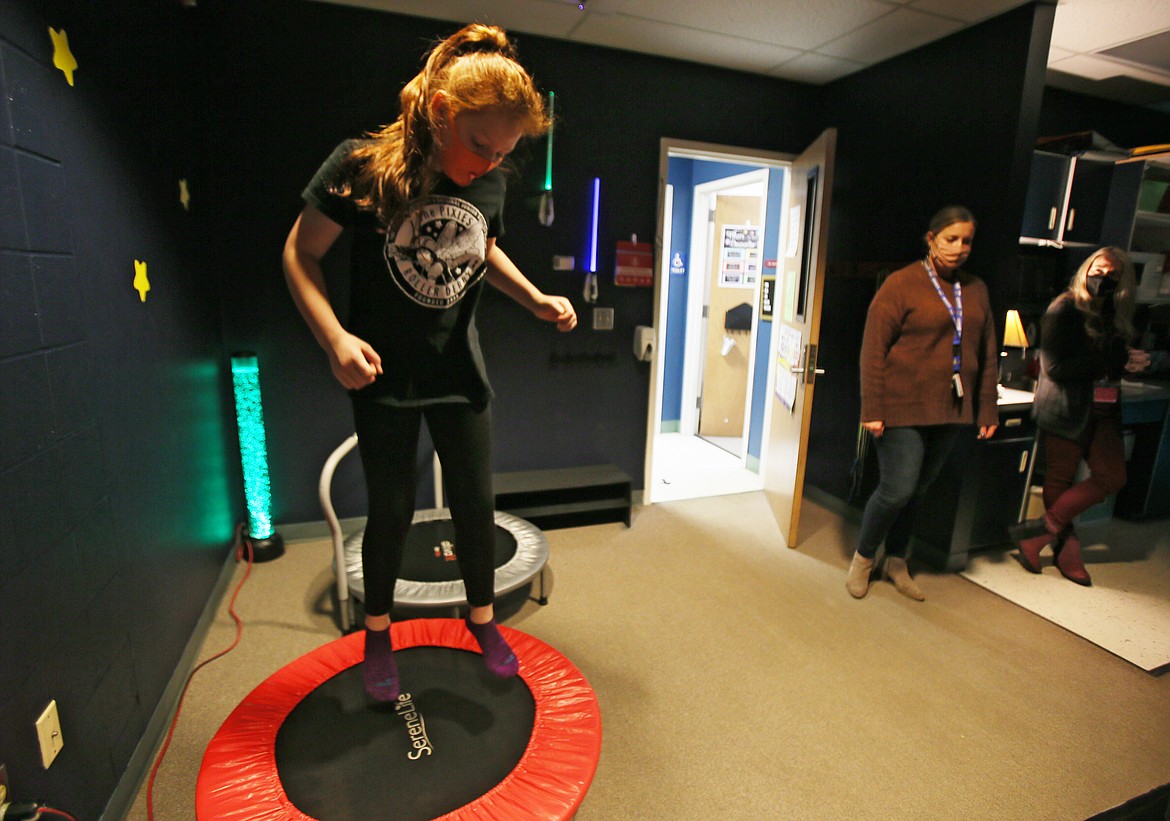 Fifth-grader River Woodworth bounces on a small trampoline Thursday morning as she shows how students use the newly upgraded sensory room in Fernan STEM Academy. Sensory rooms help individuals with sensory issues learn to regulate their brain's negative reactions to external stimuli by developing coping skills for these experiences. These safe spaces have been in use since the 1970s.