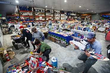 From left, volunteers Mitzi Carpenter, Debbie Rossol, Angela Wieczorek and Dennis Johnson, owner of The Party Store, sort through a load of toys donated by Bergeson RV at the Flathead County Toys for Tots distribution warehouse at The Party Store on Saturday, Dec. 12. (Casey Kreider/Daily Inter Lake)