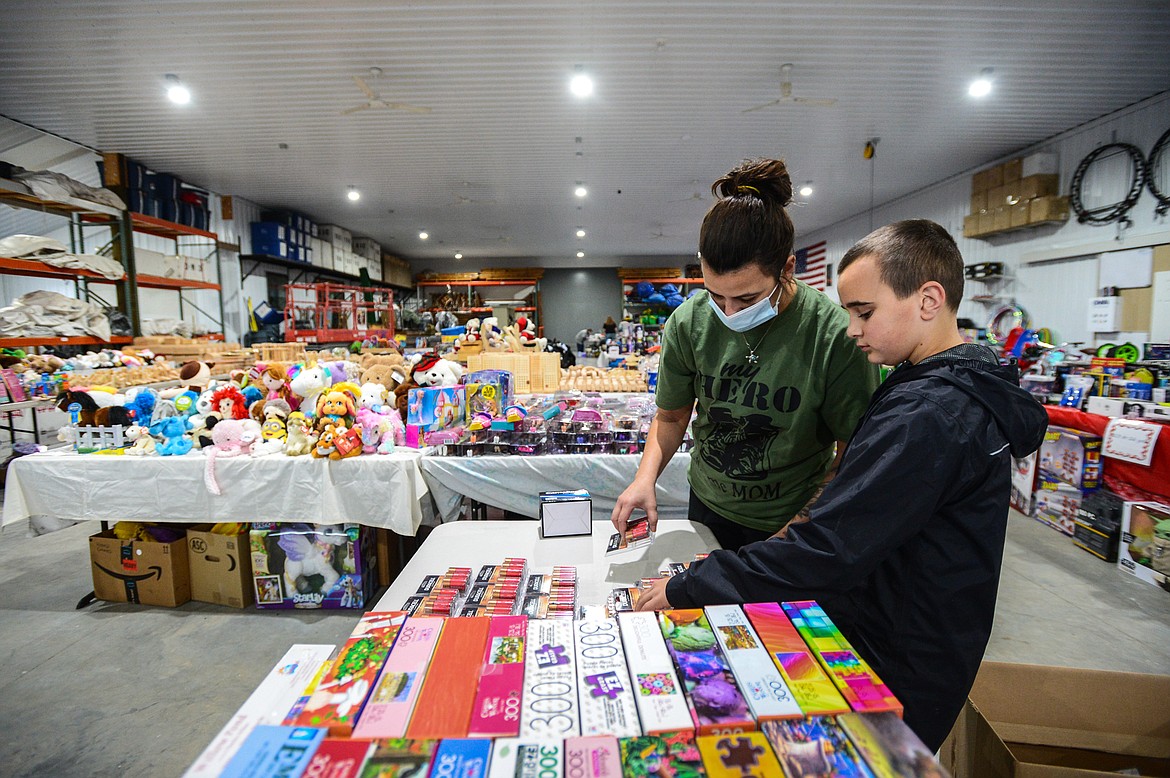 Volunteers Angela and Kalijah Wieczorek, of Kalispell, sort through items at the Flathead County Toys for Toys distribution site located at The Party Store on Saturday, Dec. 12. (Casey Kreider/Daily Inter Lake)