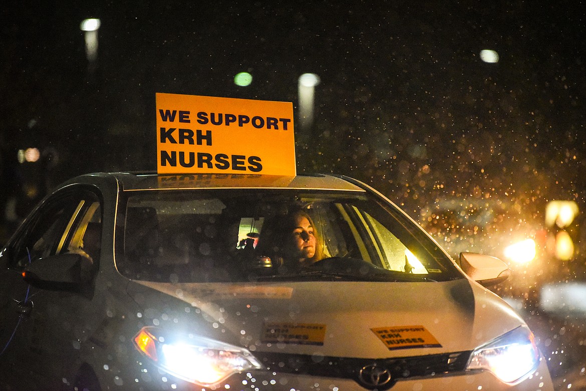 McKenna Flannigan, whose mother is a registered nurse with Logan Health, participates in the Solidarity Drive car caravan for a fair contract outside Kalispell Regional Medical Center on Friday, Dec. 11. (Casey Kreider/Daily Inter Lake)