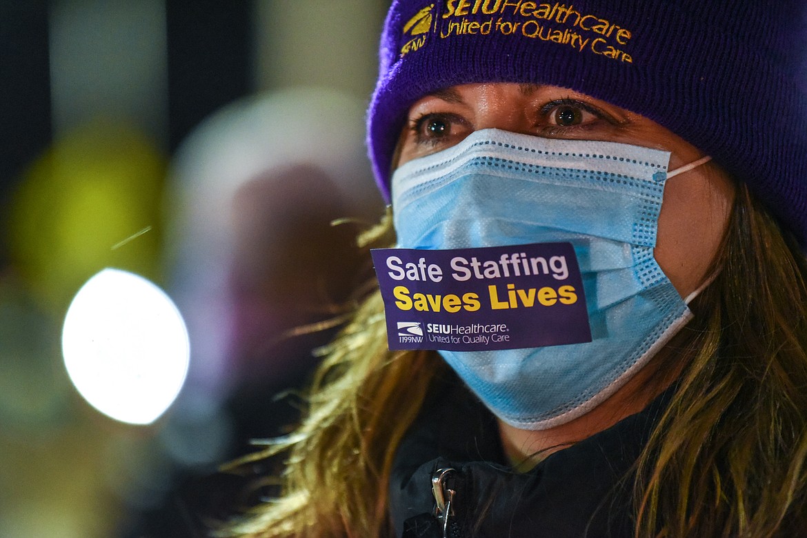 Julie Anderson, a registered nurse with Logan Health, wears a sign on her mask during a "Solidarity Drive" car caravan for a fair contract outside Kalispell Regional Medical Center on Friday, Dec. 11, 2020. (Casey Kreider/Daily Inter Lake)