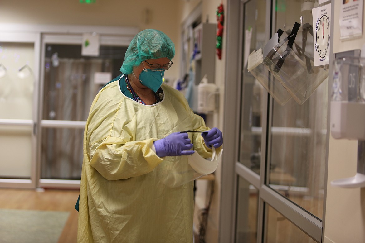 Sandy Martin, a registered nurse that works in Samaritan Hospital's ICU, gears up before going into one of the negative pressure rooms. Martin has worked in healthcare for 45 years and is one of Samaritan's most experienced veterans.