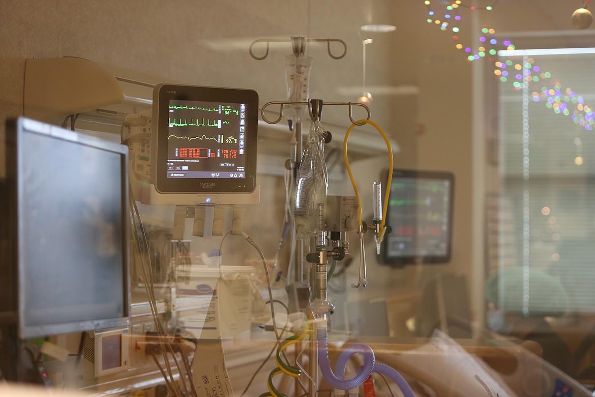 Various medical devices used to monitor a patient's vitals and to delivery oxygen line the wall next to an occupied bed at Samaritan Hospital's Intensive Care Unit.