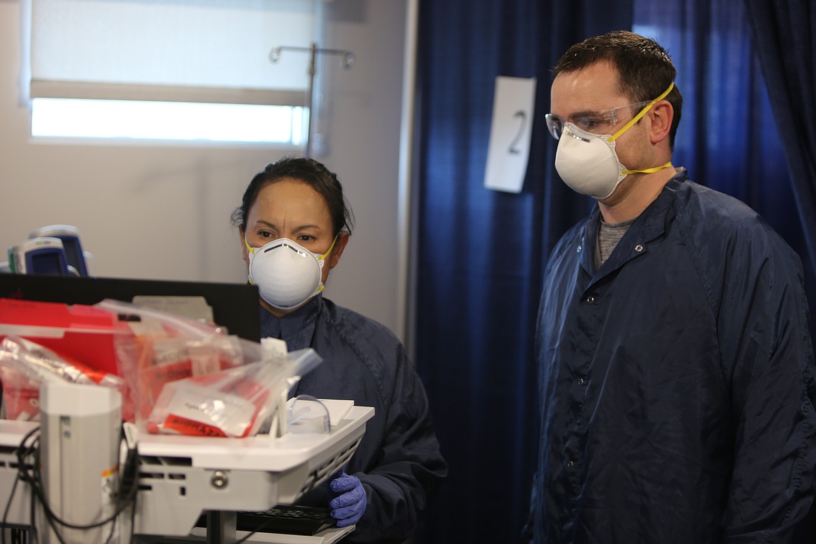 Virginia Muniz and Matt Gilbert, both nurses in the RVEC, look at some patient information on a screen inside of the center. While Gilbert has worked inside of the RVEC since shortly after the pandemic hit Grant County, Muniz transferred from Samaritan Hospital just a week ago.