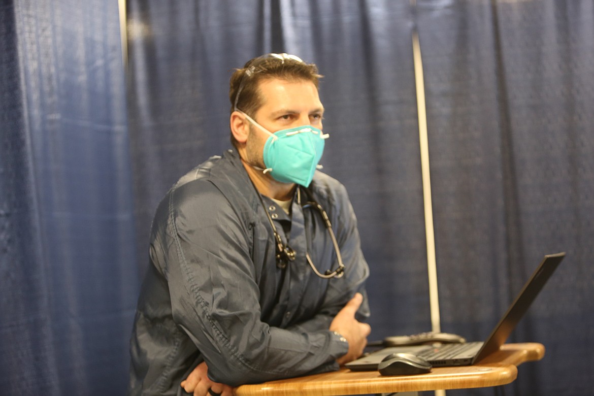 Physician’s Assistant Rich Stowe leans on a pop-up desk in Samaritan's Respiratory Virus Evaluation Center.