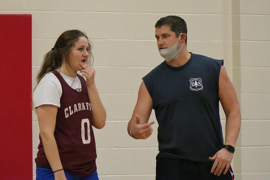 Clark Fork girls basketball coach Jeff Schultz works with 5-foot-10-inch post prospect Aubrie Constant during opening week of practice. (Chuck Bandel/Valley Press)