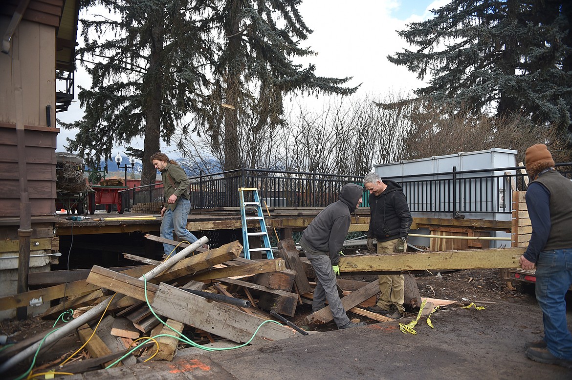 A crew from North Country Builders demolishes the damaged deck at the Train Depot last week. The deck is expected to be largely rebuilt in the next week. (Heidi Desch/Whitefish Pilot)