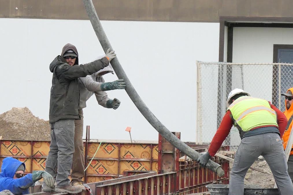 Boom truck operator Travis Campbell gets the boom hose ready to be moved into position. (Chuck Bandel/Valley Press)