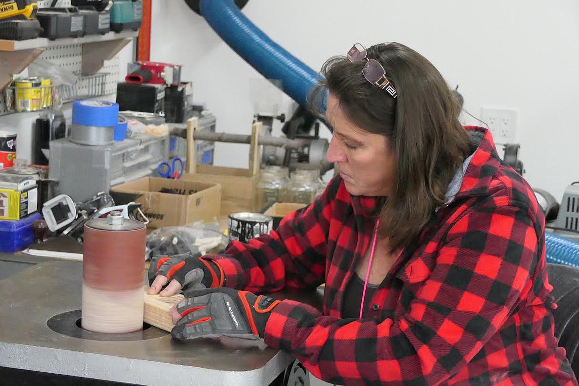 Danya Cotte puts the finishing sanding touches on one of the toy trucks she and her husband have made for children in Plains. (Chuck Bandel/Valley Press)