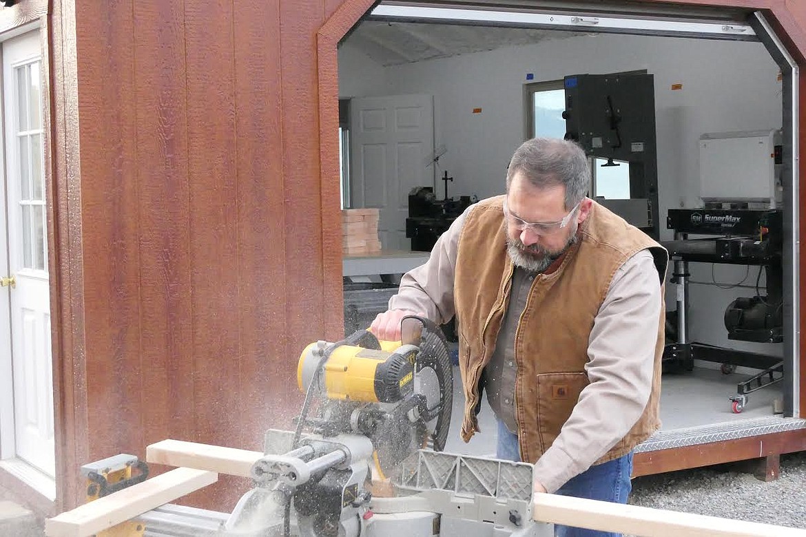 Richard Cotte cuts the sanded boards into sections. (Chuck Bandel/Valley Press)