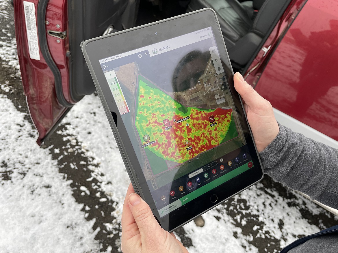 Jessica Chamberlain shows off a soil moisture display of Agrian's software on her iPad. The red spots show, for whatever reason, low moisture. "There are probably a lot of rocks in those places," she said.