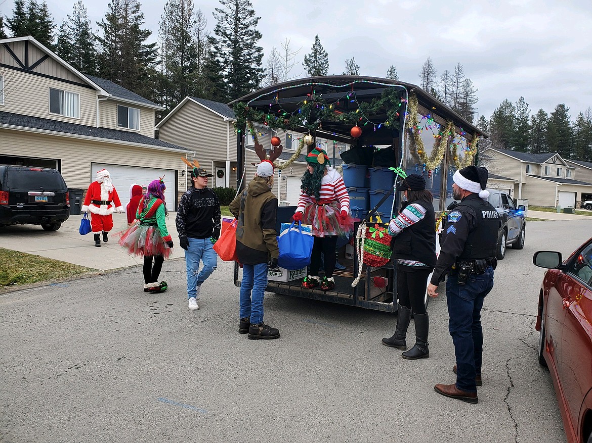 Santa and his elves make a stop at a home Saturday in Ponderay.