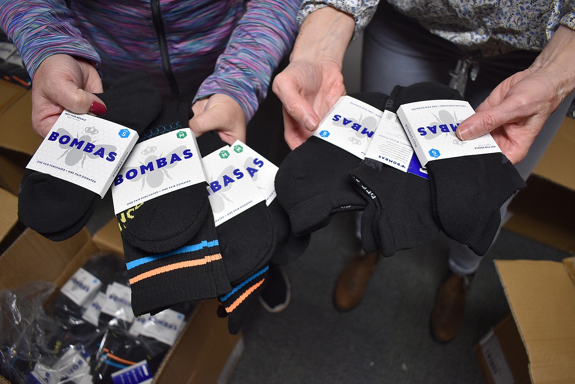 A donation of 3,000 socks from the Bombas apparel company was distributed to area school districts by Coeur Closet coordinators Paula Lyon and Polly Melendez on Monday.