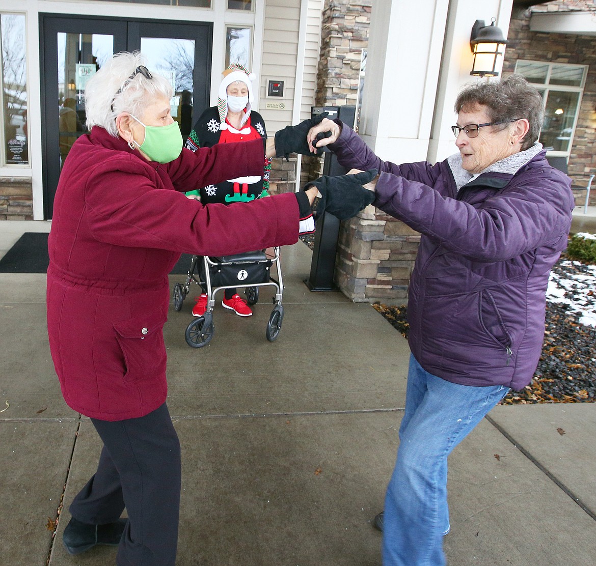 Jessie Bell, right, and Patricia Andrysiak dance to Christmas songs at Affinity at Coeur d'Alene on Tuesday.