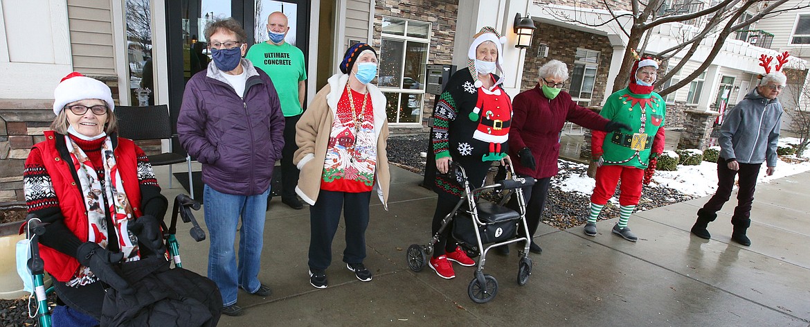 Judy McKenna, left, and friends at Affinity at Coeur d'Alene join an outside Christmas celebration on Tuesday.