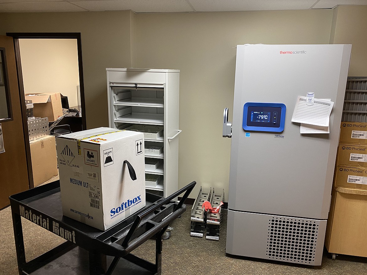 A box of COVID-19 vaccines sits next to special freezer equipment at Kalispell Regional Medical Center. The vaccine, developed by Pfizer and BioNTech, must be stored at ultra cold temperatures. (Photo courtesy of Kalispell Regional)