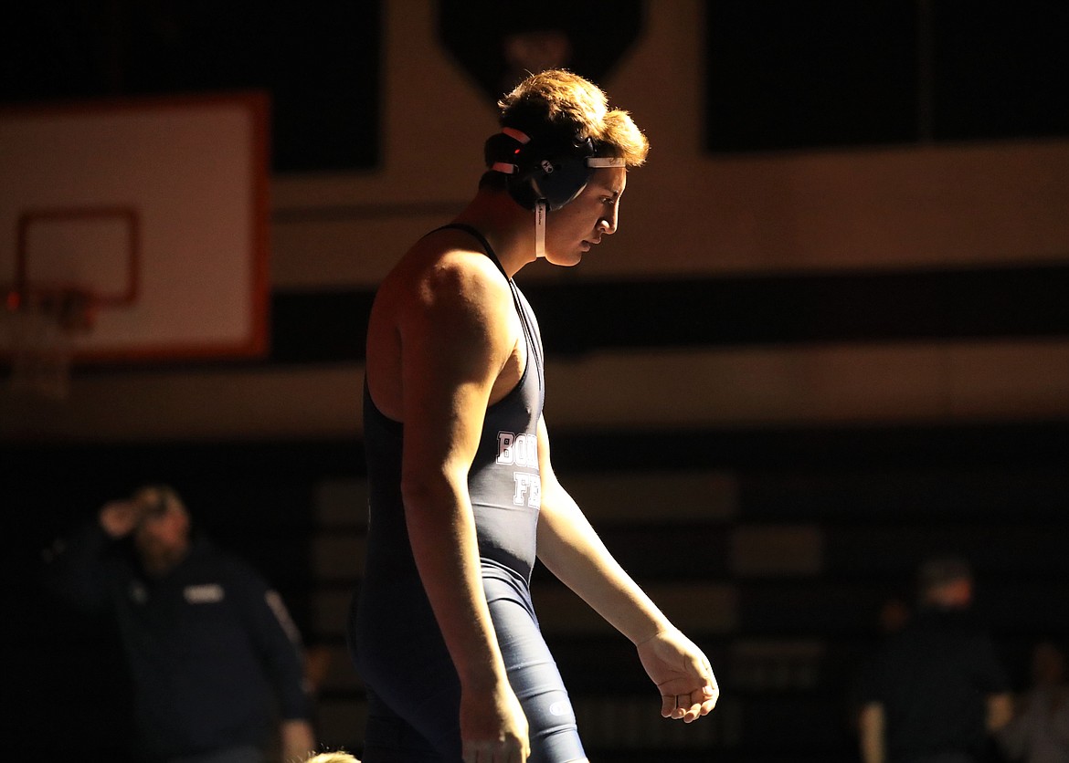 Isaiah Shottanana walks to the center of the mat to raise his fist and claim victory at 220 pounds last Thursday. Shottanana pinned his opponent in 40 seconds to secure the "B" Cup victory for the Badgers.