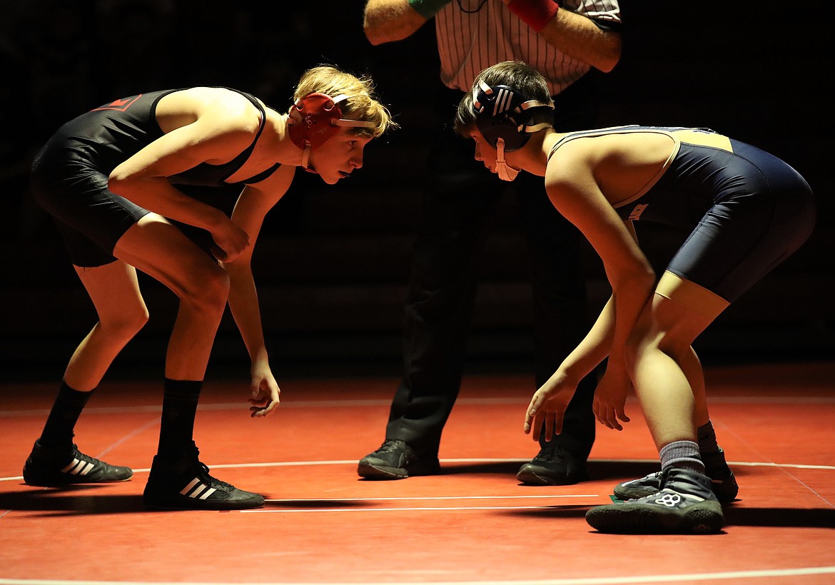 Junior Jacob Albany (left) competes in a 106-pound bout on Wednesday night.