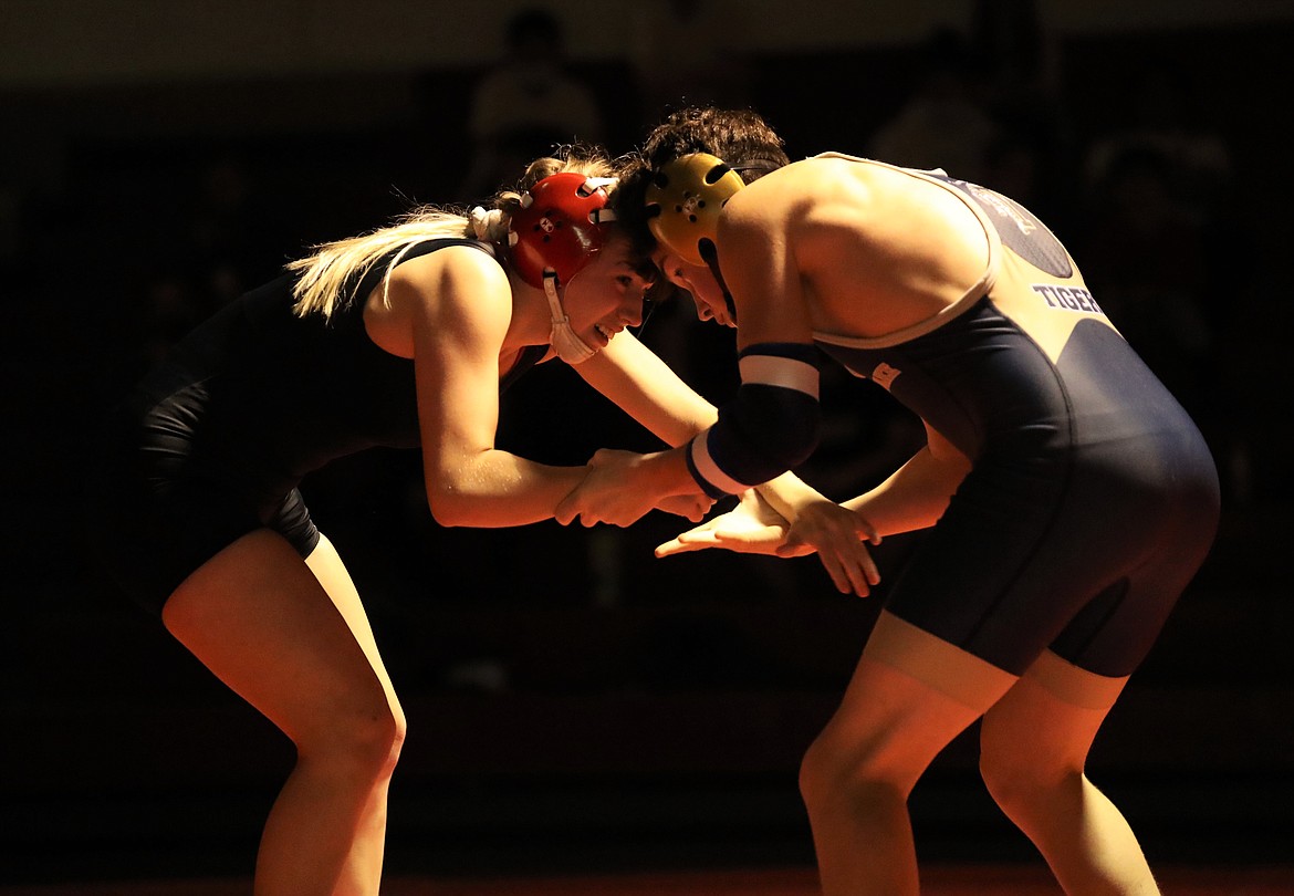 Senior Kayelin Johansen (left) battles Timberlake's Ty Gallimore in a 126-pound match on Wednesday. She won the match by pin.