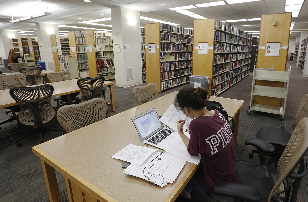 A student works in the library at Virginia Commonwealth University in Richmond, Va., June 20, 2019.