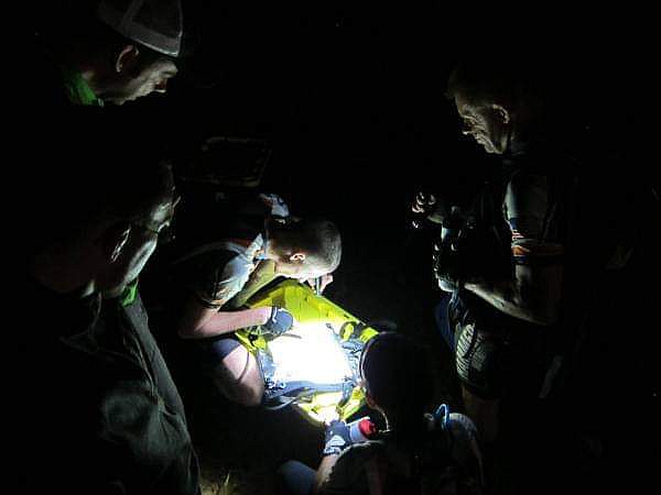 Jesse Nelson uses his flashlight to check the map during an overnight adventure race. (courtesy photo)