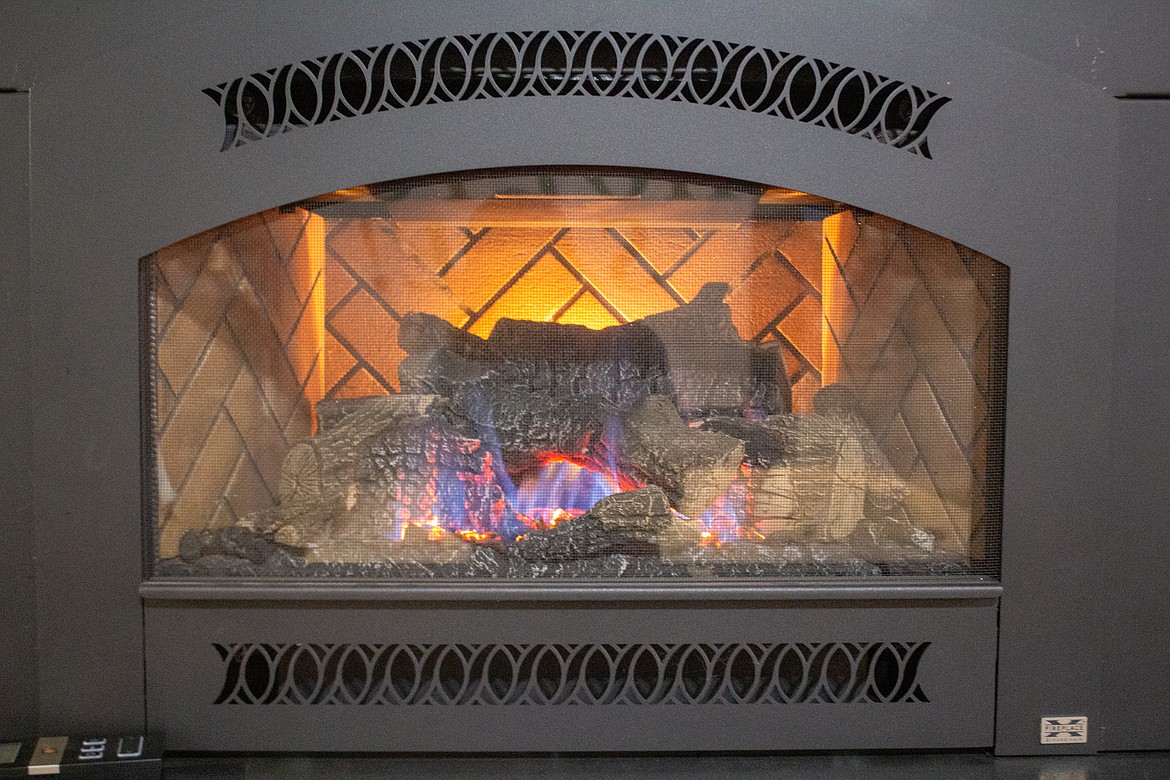 A fire burns inside of the display fireplaces at Hot Spring Spa & Leisure on Wednesday afternoon.