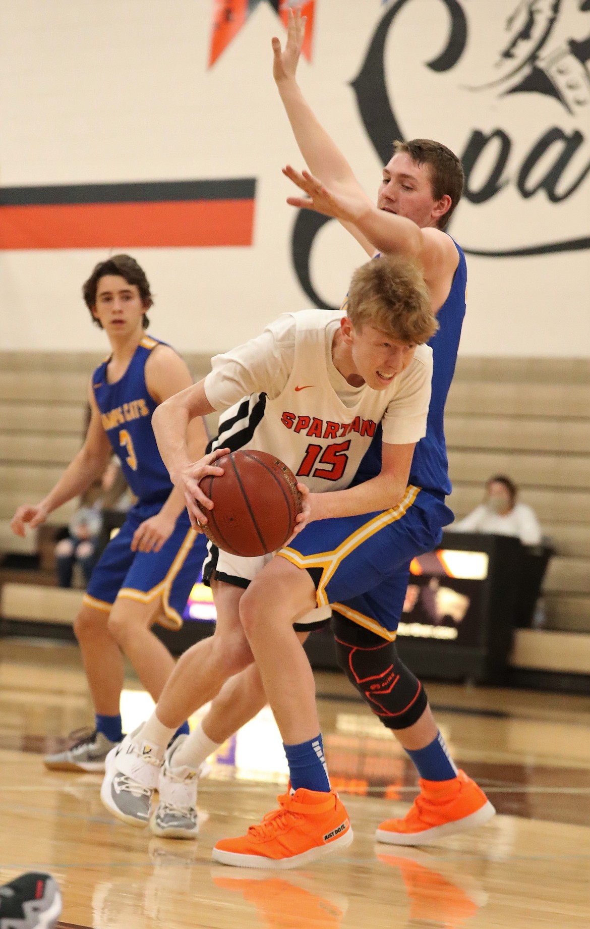 Priest River's Blake Barrett (left) attacks the paint while Clark Fork's Chris Wade defends him on Friday.