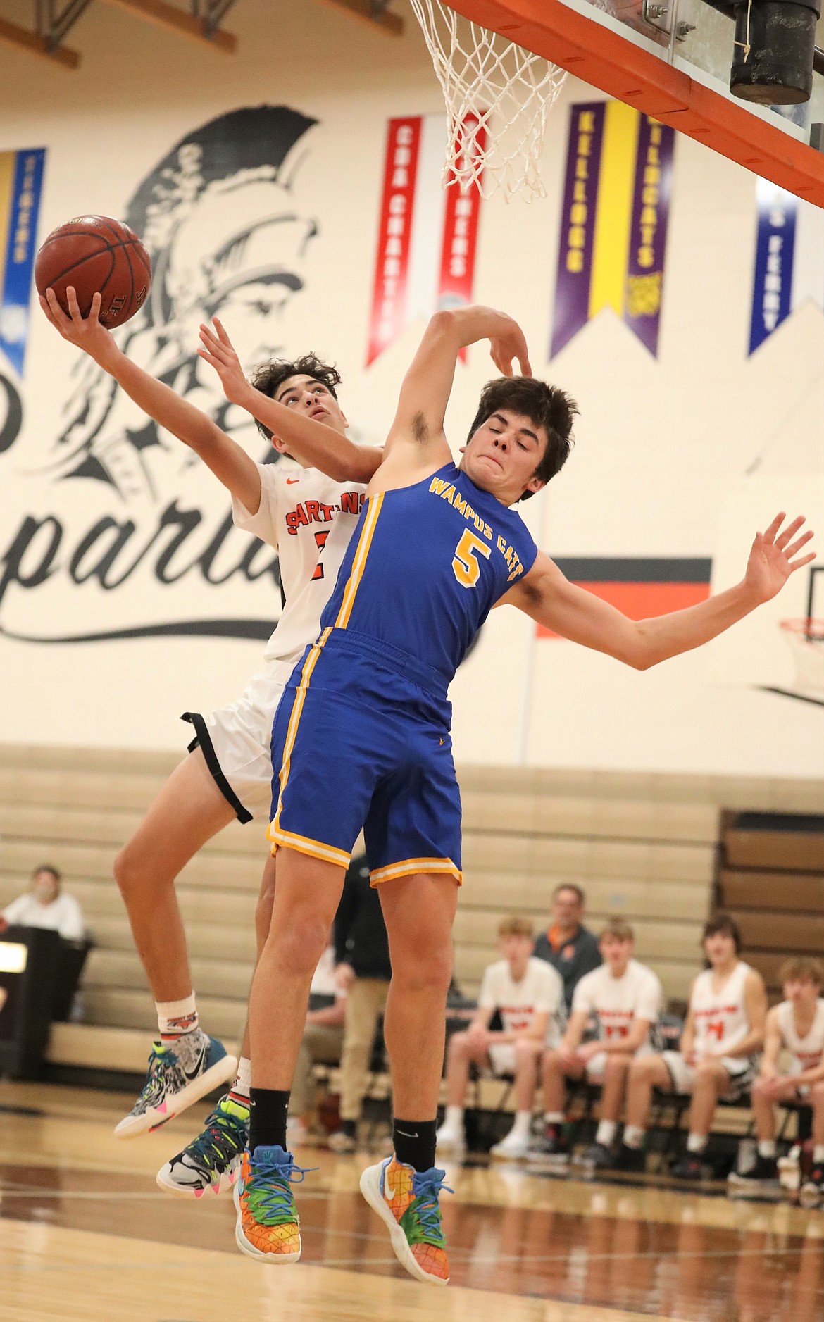 Priest River's Luke Butler (left) elevates and tries to finish a layup while Clark Fork's Carter Sanroman defends him on Friday night.