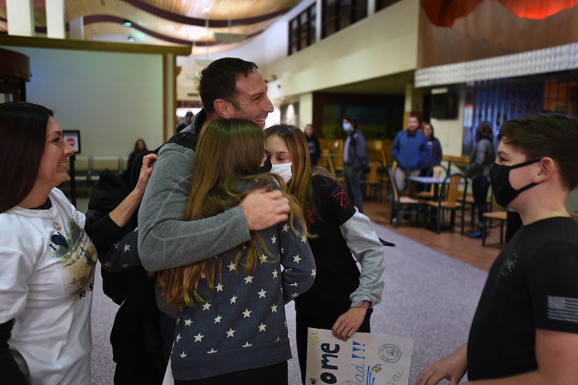 Colby Lenz gets hugs from his daughters Madison and Bristol while his son, Chance, and wife, Jessica, look on. (Jeremy Weber/Daily Inter Lake)