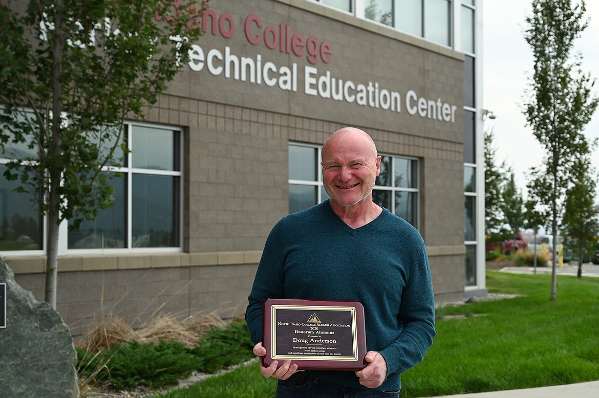 Doug Anderson, who was selected as the North Idaho College's Honorary Alumnus of the Year, holds his award plaque in front of the Parker Technical Education Center. Photo courtesy North Idaho College.