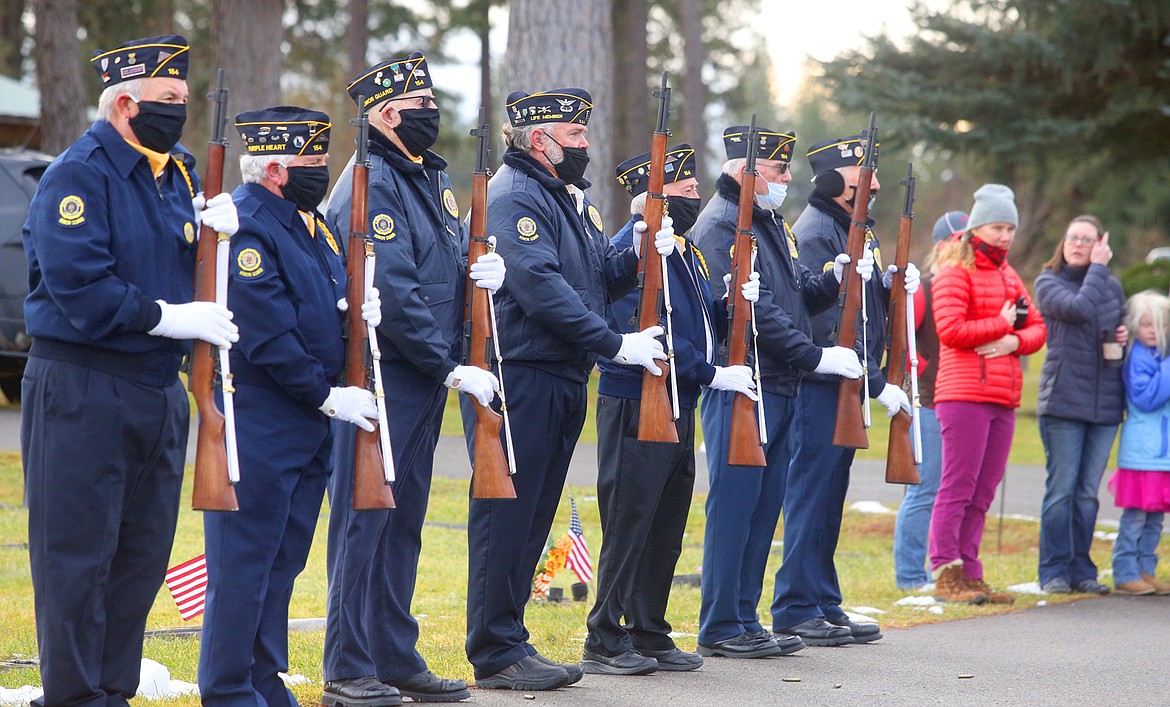 Veterans wait to fire their rifles during the National Wreaths Across America Day ceremony at Pinegrove Cemetery.