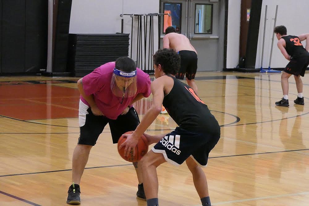 Plains boys basketball head coach Tyrel Allen guards senior Gavin Regalado during practice last week. (Chuck Bandel/Valley Press)