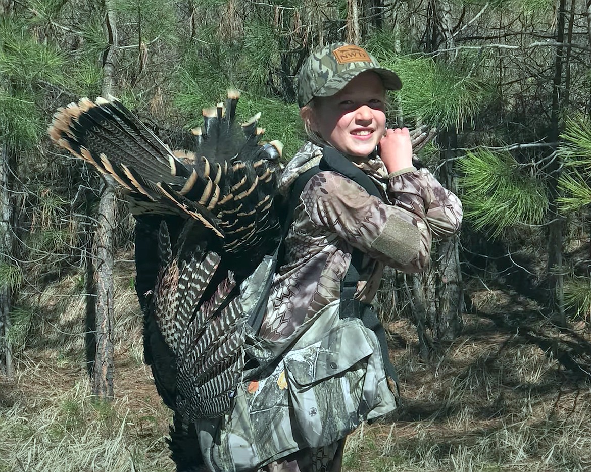 Clara poses with one of the turkeys she successfully hunted in this screenshot from the third installment of an Idaho Fish & Game video series, “Maiden Hunt”, which explores new hunters and their mentors as they learn about hunting.