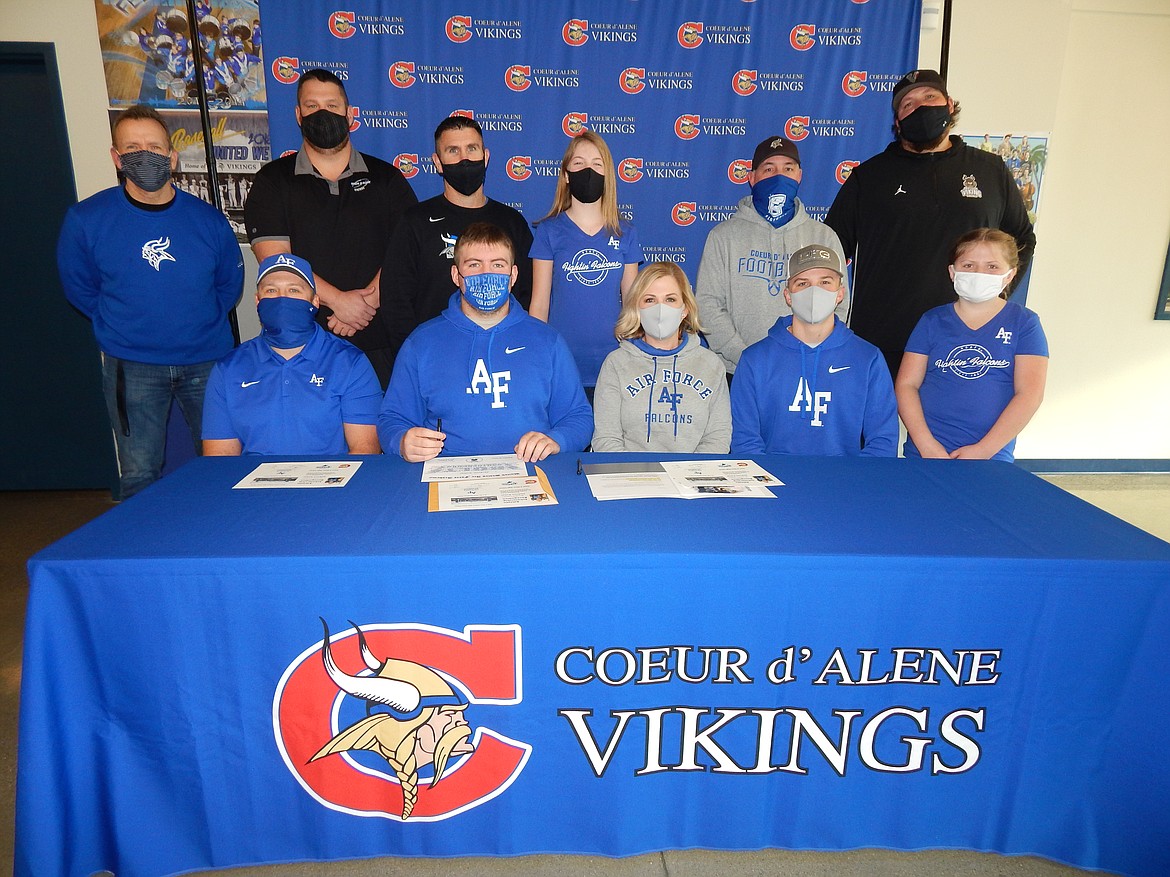 Courtesy photo
Coeur d'Alene High senior Jackson Kohal recently signed a certificate of intent to play football at the Air Force Academy. Seated from left are Tim Kohal (dad) Jackson Kohal, Sarah Kohal (mom), Joseph Kohal (brother) and Elliot Kohal (sister); and standing from left, Mike Randles, Coeur d'Alene High athletic director; Corey Brown, Coeur d'Alene High assistant football coach; Dustin Shafer, Coeur d'Alene High assistant football coach; Madison Kohal (sister), Shawn Amos, Coeur d'Alene High head football coach; and Colin Donovan, Coeur d'Alene High assistant football coach.