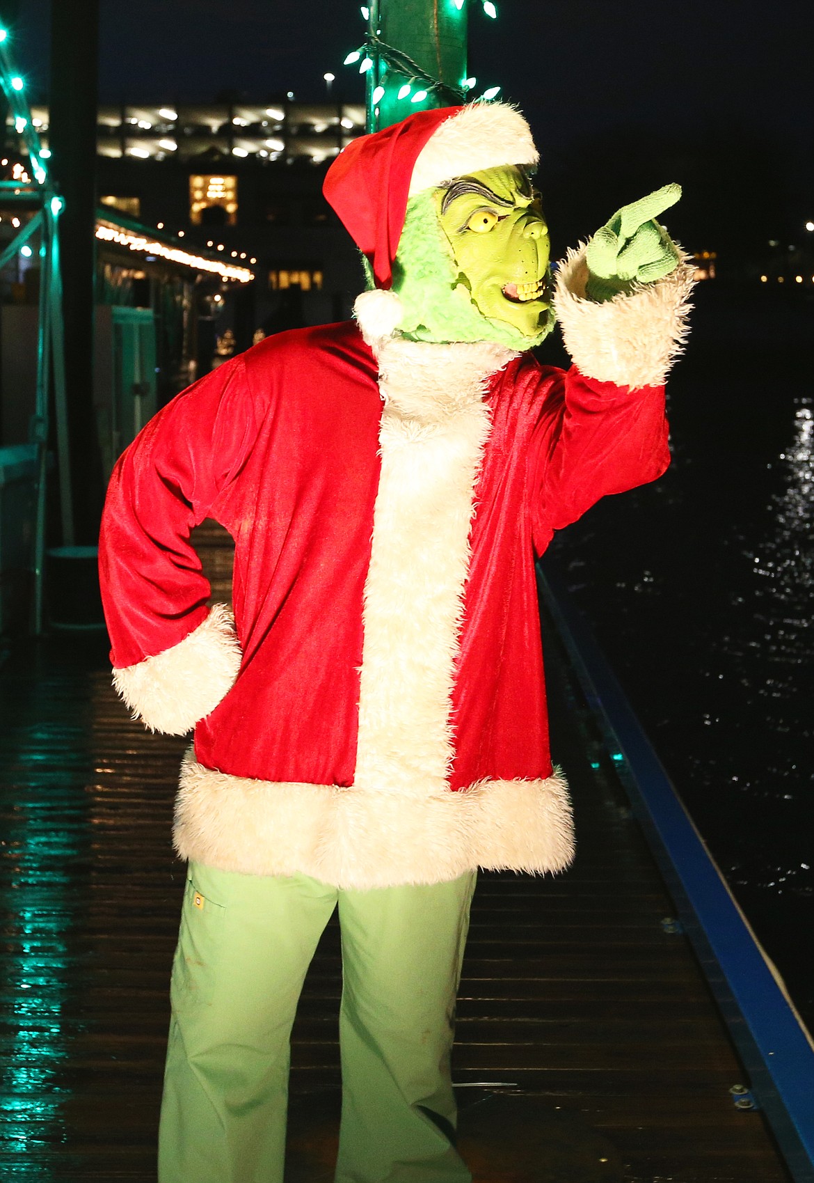 The Grinch points toward children on a Lake Coeur d'Alene Cruises boat as it departs from The Boardwalk at The Coeur d'Alene Resort.