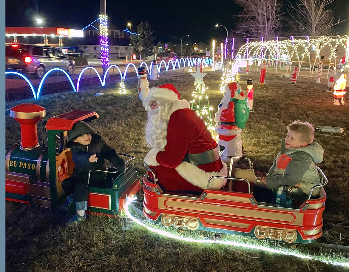 Santa Claus spends time with visitors to the holiday light show at Suntree RV Park in Post Falls.