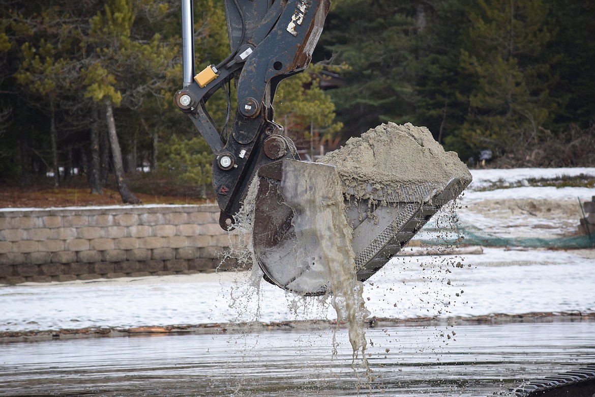 An excavator dredges sediment in the Thorofare. (Photo courtesy PRIESTLAKER.COM/D. GUYER)