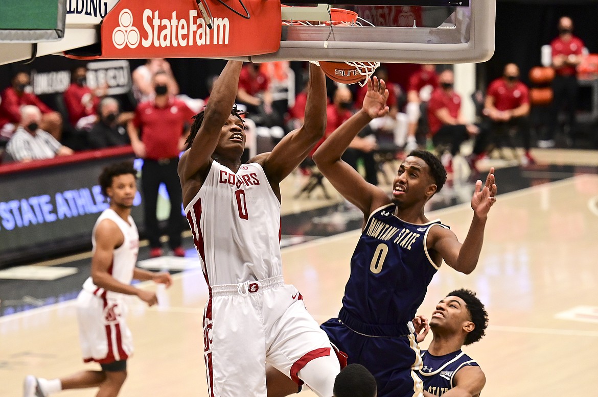 PETE CASTER/Lewiston Tribune via AP
Washington State center Efe Abogidi (0) dunks the ball as Montana State forward Abdul Mohamed (0) defends in a Dec. 18 game in Pullman.