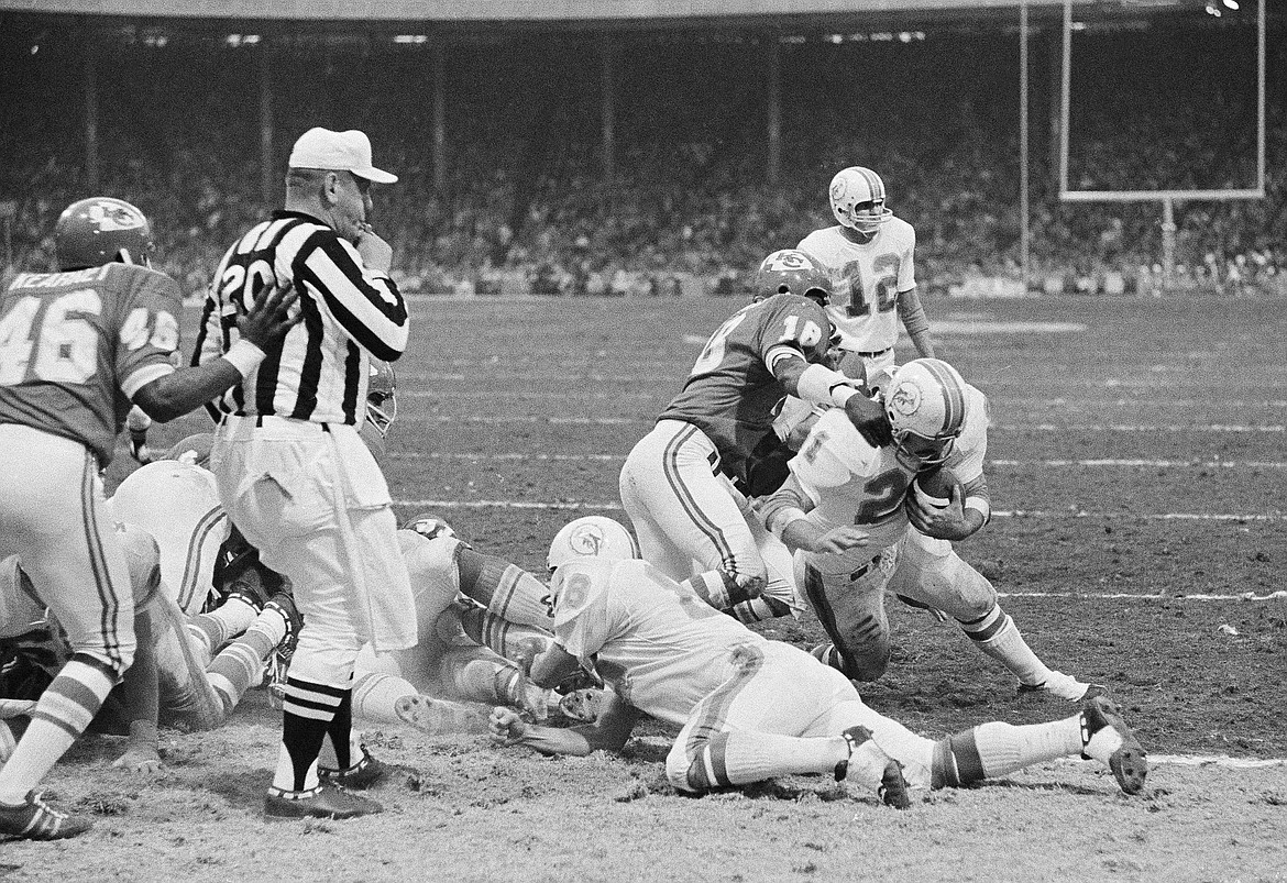 Associated Press
Miami running back Jim Kiick ducks under the tackle by Kansas City’s Emmitt Thomas (18) to score in the Christmas Day playoff game in 1971 at Municipal Stadium in Kansas City.