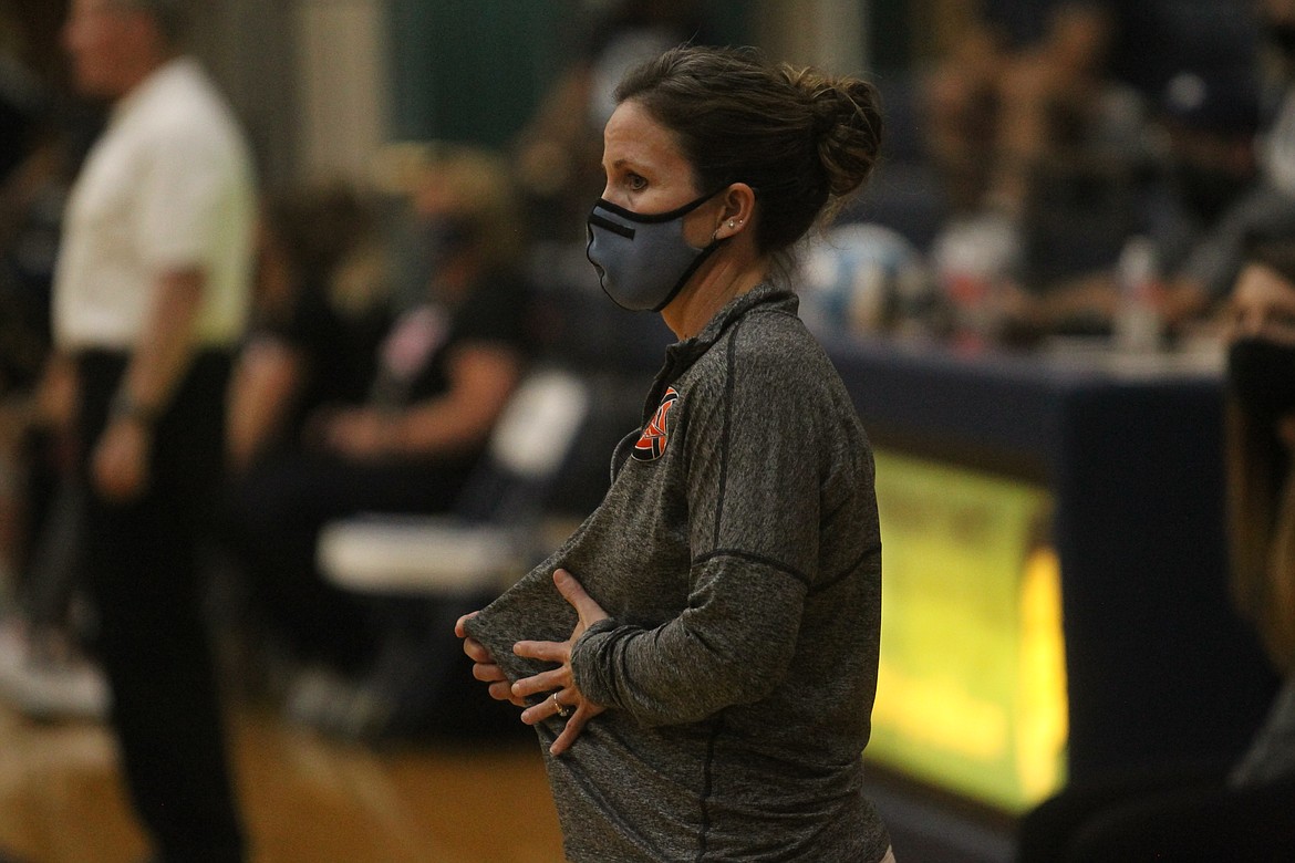 MARK NELKE/Press
Post Falls volleyball coach Willow Hanna, wearing a mask per COVID-19 protocols, signals a service location during a match with Lake City.
