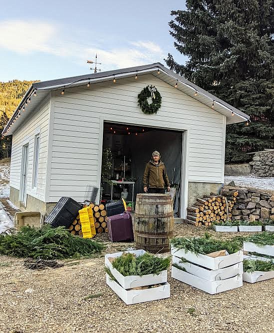 Michael Davidson sets up his newly built veggie-prep shed for the Christmas Market at Crescent Ridge Farm. (Photo provided by Molly Davidson)