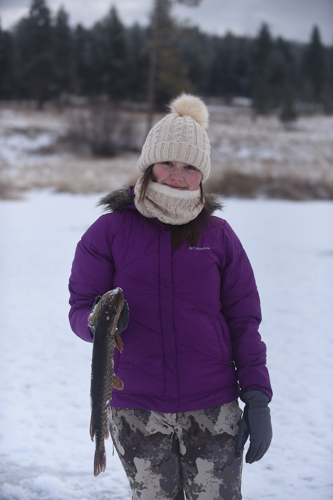 Thirteen-year-old Elizabeth Peterson, of Thompson Falls, shows off a 21-inch northern pike she caught last Saturday at the Kalispell Sunriser Lions Club fishing derby at Smith Lake. (Scott Shindledecker/Valley Press)