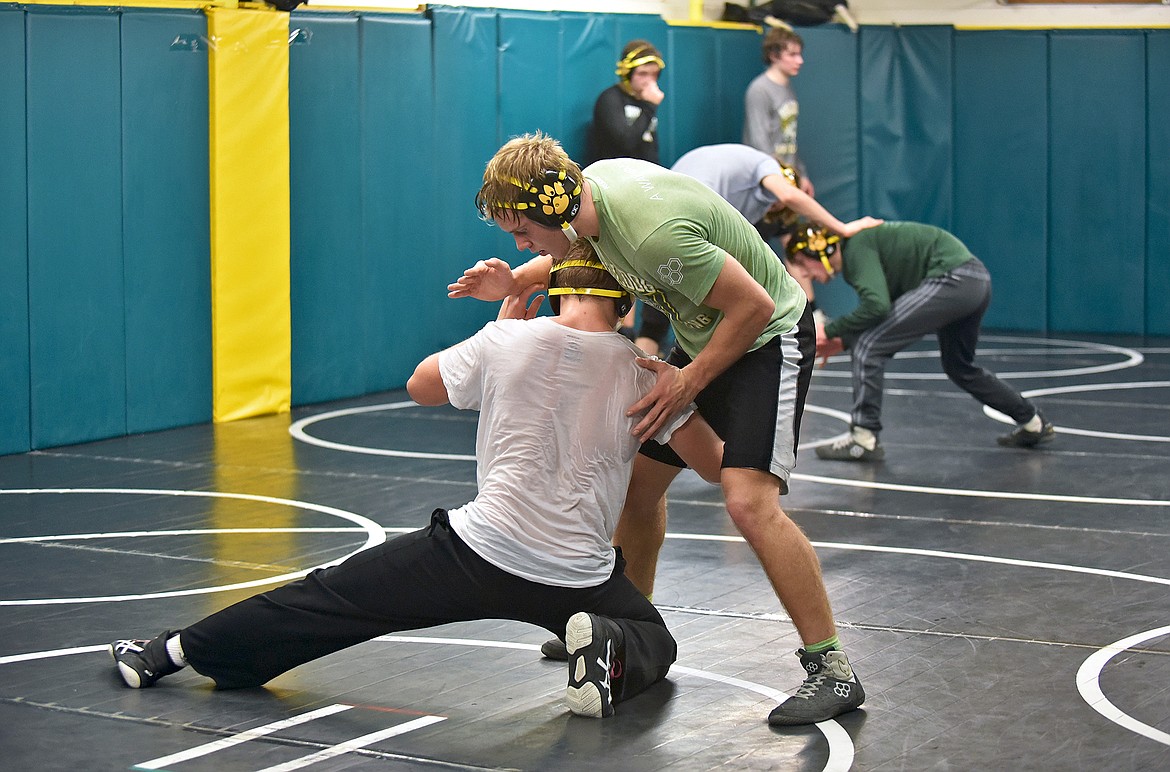 Bulldog Rylee Creasey practices shooting on Camren Ross during a wrestling practice on Dec. 9. (Whitney England/Whitefish Pilot)