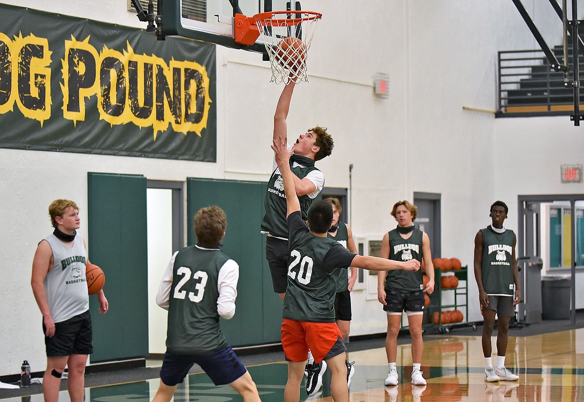 Bulldog Jack Sears takes a shot over the defense during a drill at the boys basketball practice on Dec. 9. (Whitney England/Whitefish Pilot)