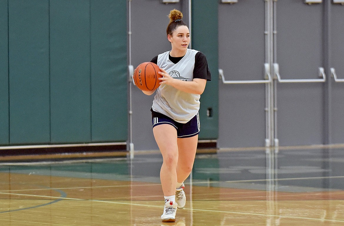 Lady Bulldog senior Gracie Smyley looks to pass the ball during a drill at the girls basketball practice on Dec. 10. (Whitney England/Whitefish Pilot)