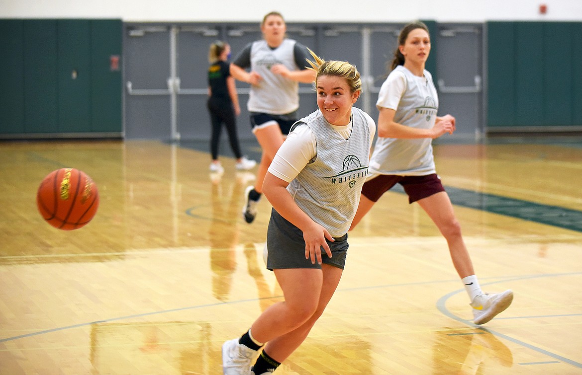 Whitefish senior Ashton Ramsey tries a behind-the-back pass during  basketball practice on Dec. 10. (Whitney England/Whitefish Pilot)